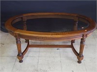 Glass top oval coffee table 27x45. Cherry.