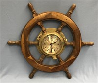 Ship's wheel and brass clock        (i52)