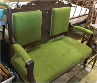 Antique settee sofa with green upholstery, on