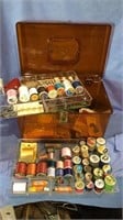 Vintage sewing box filled with sewing items,