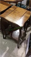 Tall side table with inlaid wood top, shelf below