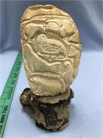 Relief carved walrus cheek bone with a seal, whale