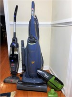 Three vacuums with cords