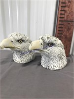 Two concrete eagle heads-- weathered paint