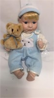 11 inch porcelain boy sitting with teddy bear