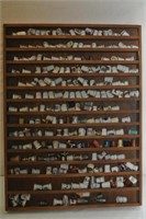 Collection of over 200 thimbles in hanging rack
