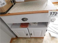 Small cabinet with attached toilet paper holder,