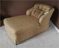 Gold chaise lounge with accent pillow