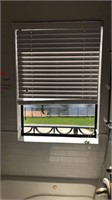 PGT impact solid pane window with the blinds