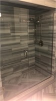 Frameless shower enclosure