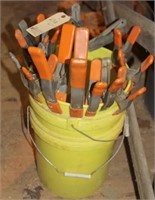 Bucket of 14 spring clamps & 2 bench dogs
