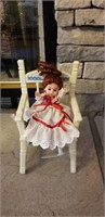 Cute little baby doll in chair