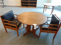 round table and two chairs leather cushions