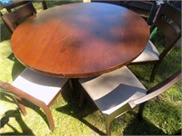 round dark wood table with 6 chairs