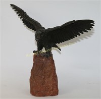 BRONZE EAGLE MOUNTED ON A RED ROCK