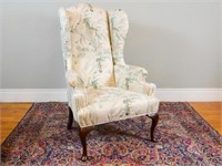 White upholstered wingback armchair