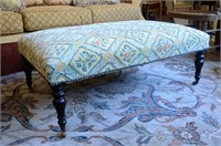 Tapestry upholstered ottoman with turned wood legs
