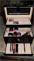 Leather makeup case with makeup and nail polish