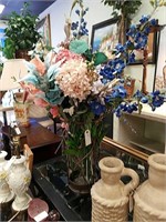 Metal garden vase with diverse flowers