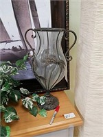 Glass vase with metal palm trees on outside of
