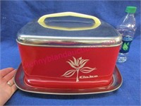 old red metal cake carrier