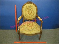 ornately carved needlepoint armchair