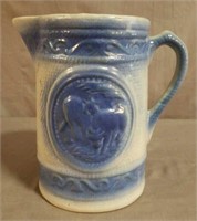 8in. Early Stoneware Embossed Cattle Pitcher