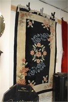 Black, cream floral rug.