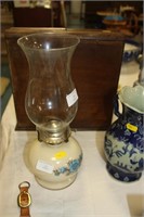 Small china oil lamp with glass shade.