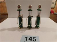 Three miniature Sinclair glass top gas pumps,
