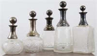 SET OF FIVE CUT GLASS WITH SILVER TOP DECANTERS