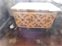 Vintage upholstered sewing box on high legs, with