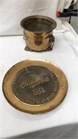 Brass Oldsmobile calendar year sells plate with