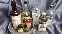 7 old bottles with labels