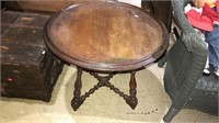 Round Victorian walnut table with a stretcher