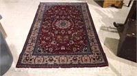 Nice oriental rug with a burgundy background,