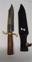 Massive modern bowie knife with brass strip on