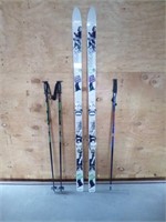 6ft Tyrolia skis with a pair of 4ft ski poles