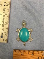 Silver alloy pendant with turquoise colored stone