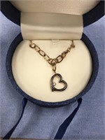 Bronze toned chain link bracelet with a heart pend