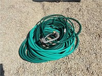 assortment of garden hose and sprinkler