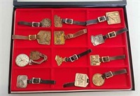 12 Watch fobs in display case