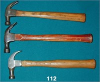 Three wooden handled claw hammers