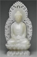 A QING DYNASTY WHITE JADE FIGURE OF BUDDHA 18TH C