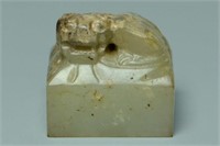A CALCIFIED JADE SEAL WITH CHARACTERS