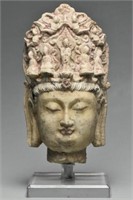 A TANG DYNASTY LIMESTONE HEAD OF BUDDHA AND STAND