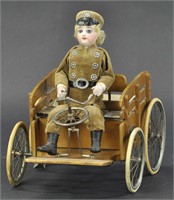 BISQUE "CHAUFFEUR" IN HORSELESS CARRIAGE