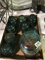 small green insulators and blue glass jars
