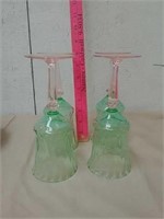 4 green wine glasses with pink stems