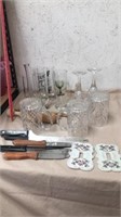 Group of kitchen glasses, knives, would utensils,